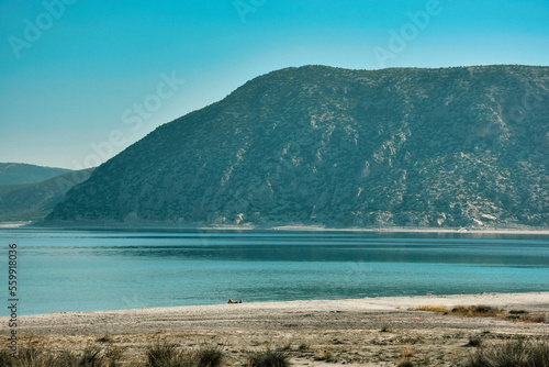 Beach of Salda Lake  in Burdur Turkey.A woman sunbathing on the beach.The lake sedimentary records show high resolution climate changes that are related to solar variability during the last millennium