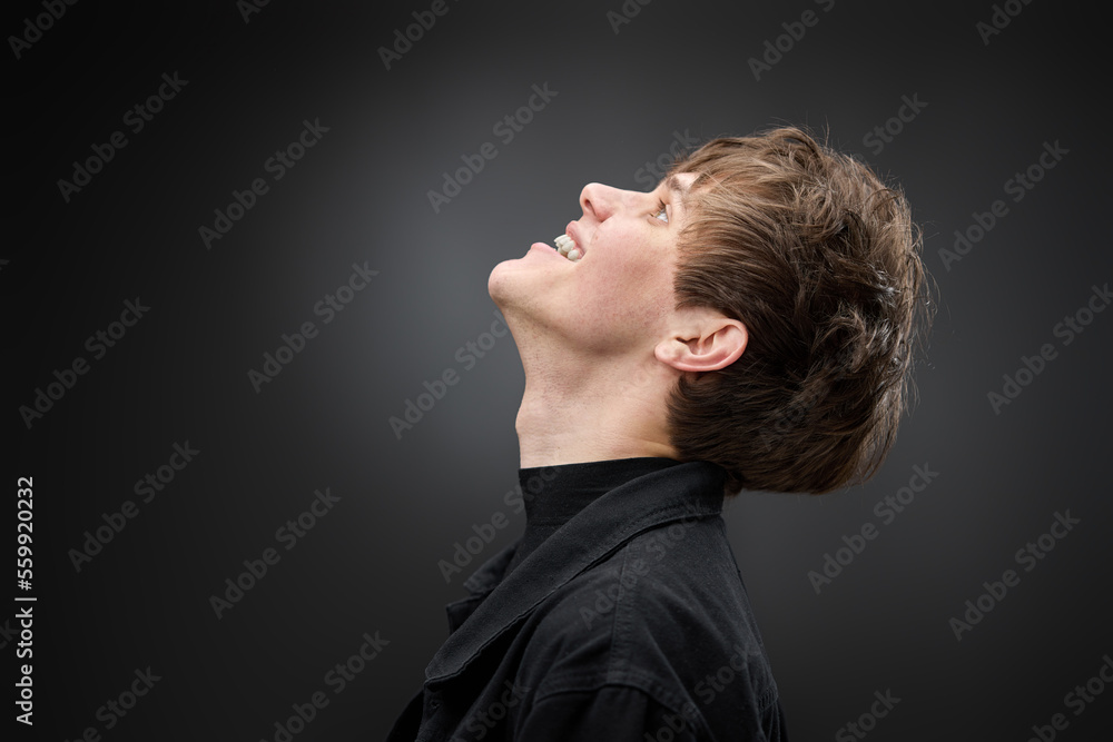 positive handsome man laughing on black background positive handsome man laughing on black background