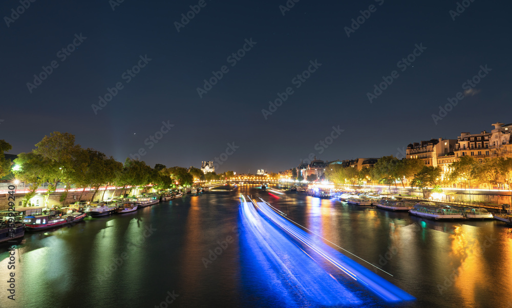 Night time view Paris with Seine river canal