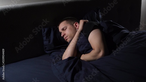 Disturbed sleep. I have nightmares. The young guy tosses and turns in bed.