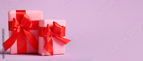 Gift boxes for Valentine's Day on lilac background with space for text