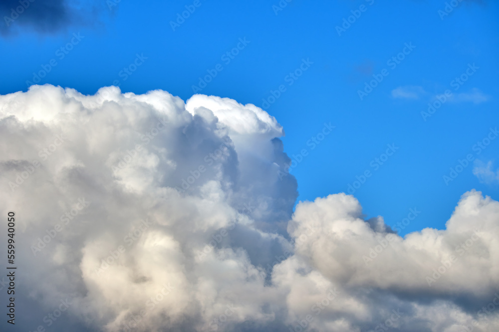 Bright landscape of white puffy cumulus clouds on blue clear sky Bright landscape of white puffy cumulus clouds on blue clear sky