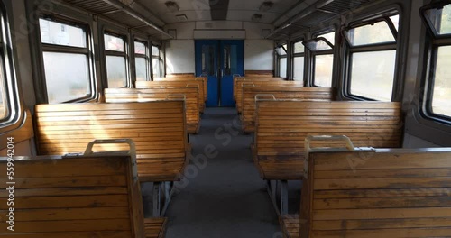 Interior of old empty wagon of train. Wooden seats in an empty coach of suburban train photo