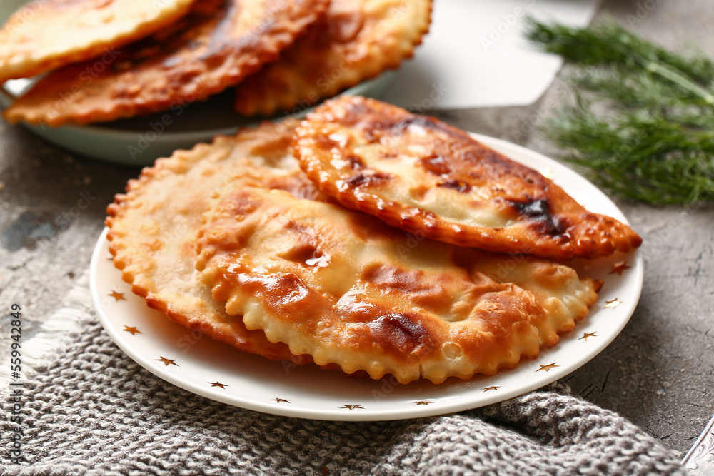 Plate with tasty chebureks on table Plate with tasty chebureks on table