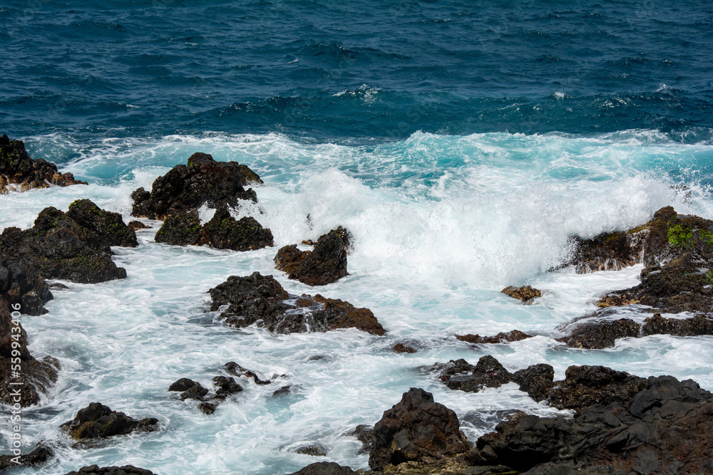 Lava stones in the surf Lava stones in the surf