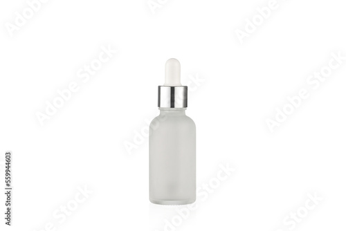 Matte white bottle with dropper on a white background.
Cosmetic bottle. Frosted glass bottle with silver metallic cup.