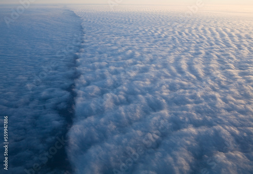 Clouds pass below during a flight across the country. photo