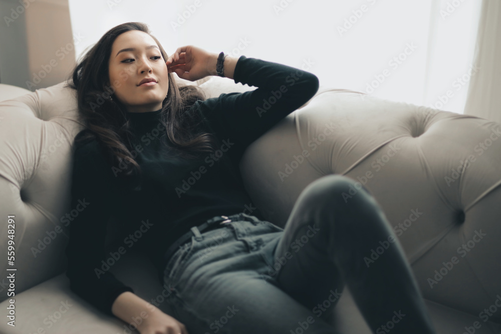 portrait of a beautiful young woman on a sofa portrait of a beautiful young woman on a sofa