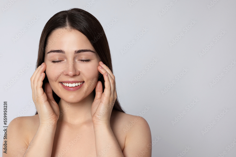 Portrait of attractive young woman on light grey background, space for text. Spa treatment Portrait of attractive young woman on light grey background, space for text. Spa treatment
