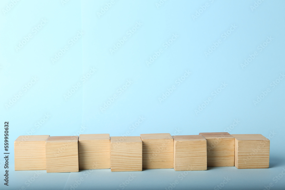 Empty cubes on light blue background, space for design Empty cubes on light blue background, space for design