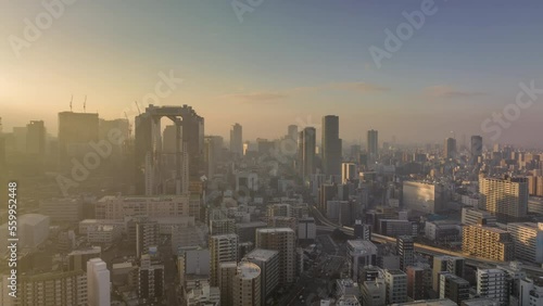 Aerial time lapse of sunrise on hazy morning in Osaka city center