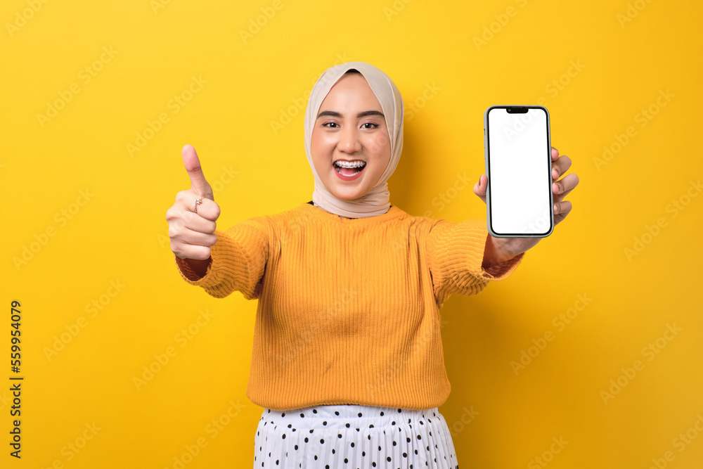 Beautiful cheerful Asian girl wearing hijab showing mobile phone with ...