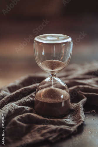 hourglass on wooden table