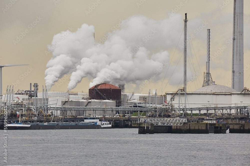 Industrial oil port and facilities smoking in the background Industrial oil port and facilities smoking in the background