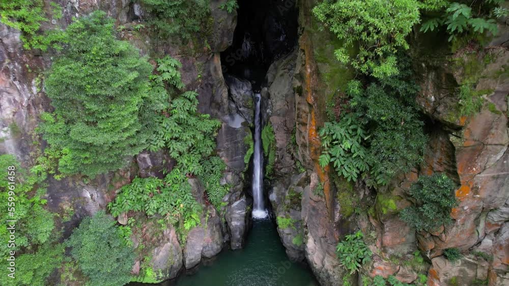 Drone dolly toward scenic Salto do Cabrito waterfall in canyon, São Miguel Drone dolly toward scenic Salto do Cabrito waterfall in canyon, São Miguel