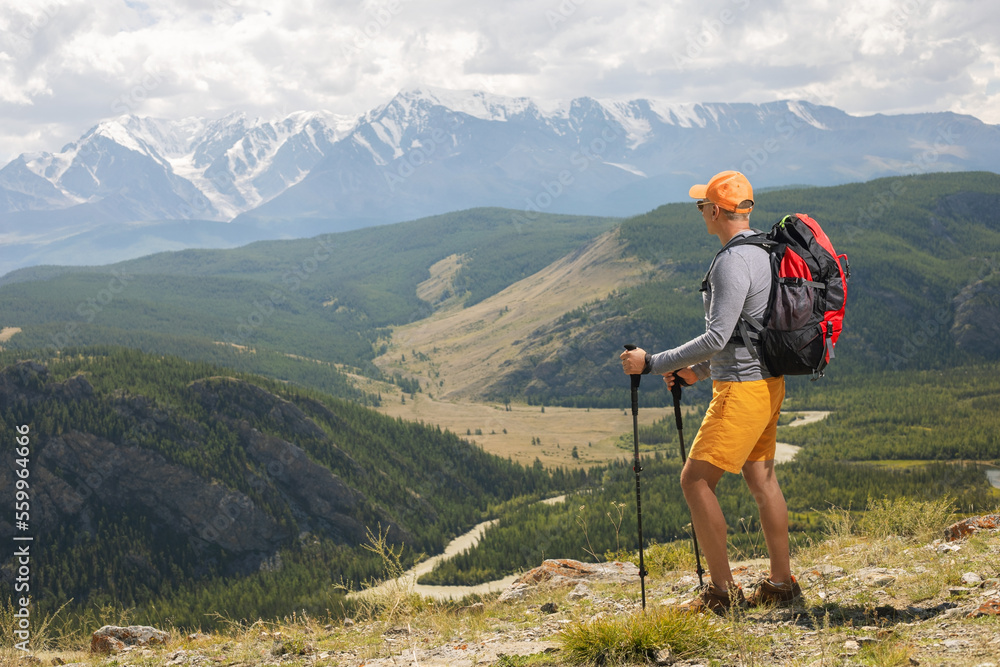 Man traveling with backpack hiking in summer mountains. healthy lifestyle concept active summer vacations
