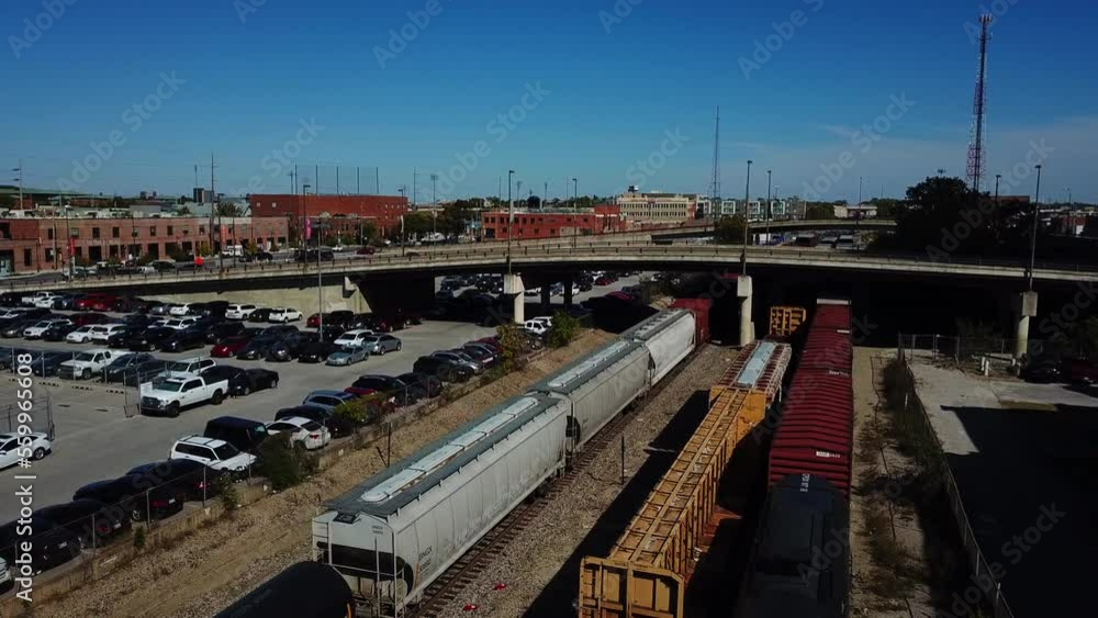 Slow aerial dolly forward with a delivery train leaving after its dropoff Slow aerial dolly forward with a delivery train leaving after its dropoff
