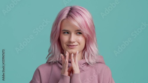 Cunning young woman pink hairstyle in hoodie thinking devious tricks cheating 4K photo