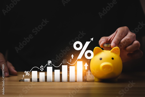 interest rates and dividends, investment returns, income, retirement Compensation fund, investment, dividend tax. pile of coins and upward direction percentage symbol. saving money for investment