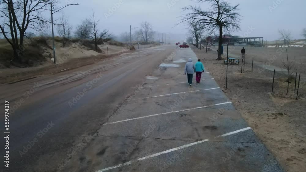 Folks walking along the Beach Road during a Winter Heatwave. Folks walking along the Beach Road during a Winter Heatwave.