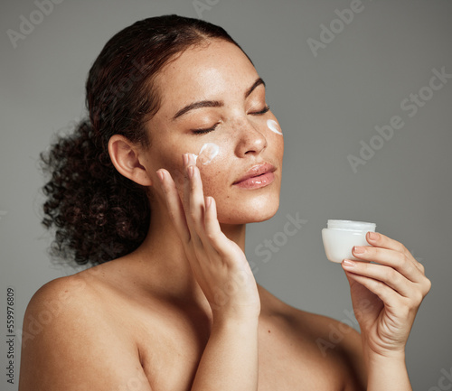 Fotografija Black woman, face and skincare cream for beauty wellness shine, cosmetics dermatology and salon spa product in studio