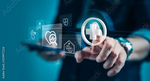 Businessman using smartphone with virtual medical health care icons for medical treatment service
