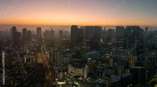 Aerial view of predawn glow and lights from central Osaka buildings