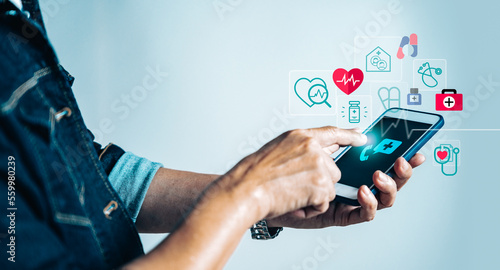 Businessman using smartphone application with virtual medical health care icons for health service