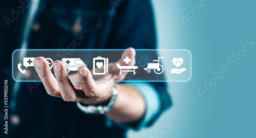 Businessman hand holding virtual medical health care icons for health service