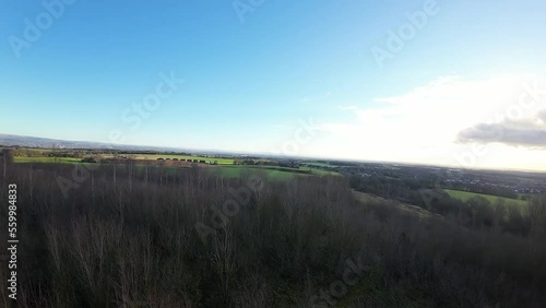 FPV drone flying across Billinge hill beacon autumn trees and Lancashire farmland landscape photo