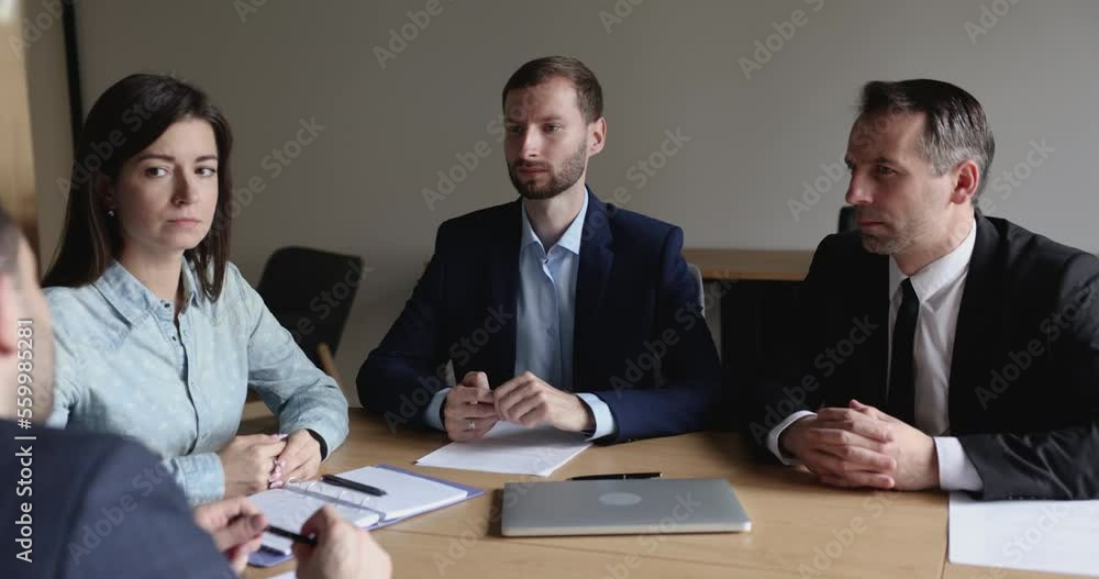 Caucasian businessman, team leader talk to employees at formal meeting, executive manager explain project details, business plan, discussing work results at corporate group briefing. Business workflow Caucasian businessman, team leader talk to employees at formal meeting, executive manager explain project details, business plan, discussing work results at corporate group briefing. Business workflow