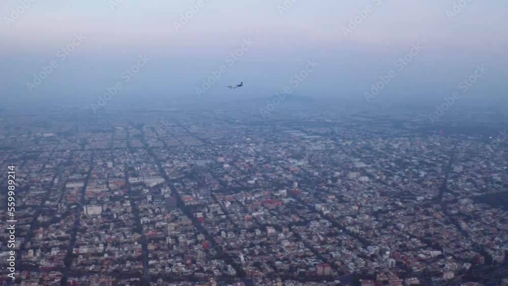 Commercial airplane flies over Mexico City at blue hour, after sunset. Commercial airplane flies over Mexico City at blue hour, after sunset.