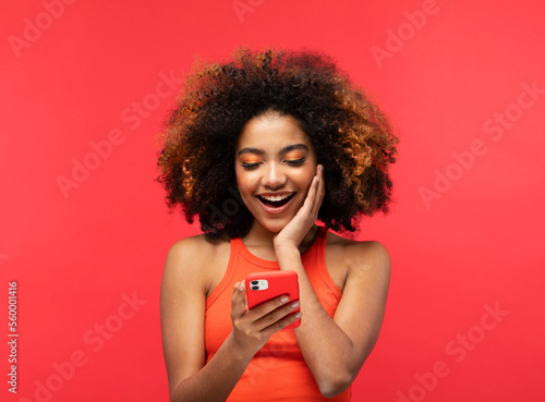 lifestyle, tehnology and people concept: Portrait of inspired dreamy american young surprised woman use her smartphone