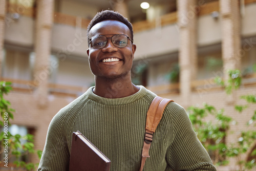 University student, black man and portrait at campus for education, learning and studying in Atlanta. Happy young male college student with motivation for knowledge, scholarship opportunity and goals