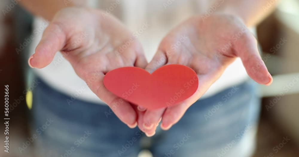 Woman hands holding red paper hearts Woman hands holding red paper hearts