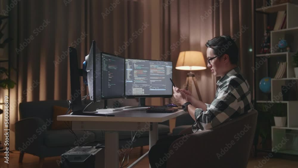 Asian Male Programmer Looking At Database On Smartphone While Creating Software Engineer Developing App, Program, Video Game On Desktop Computer At Home
Asian Male Programmer Looking At Database On Smartphone While Creating Software Engineer Developing App, Program, Video Game On Desktop Computer At Home