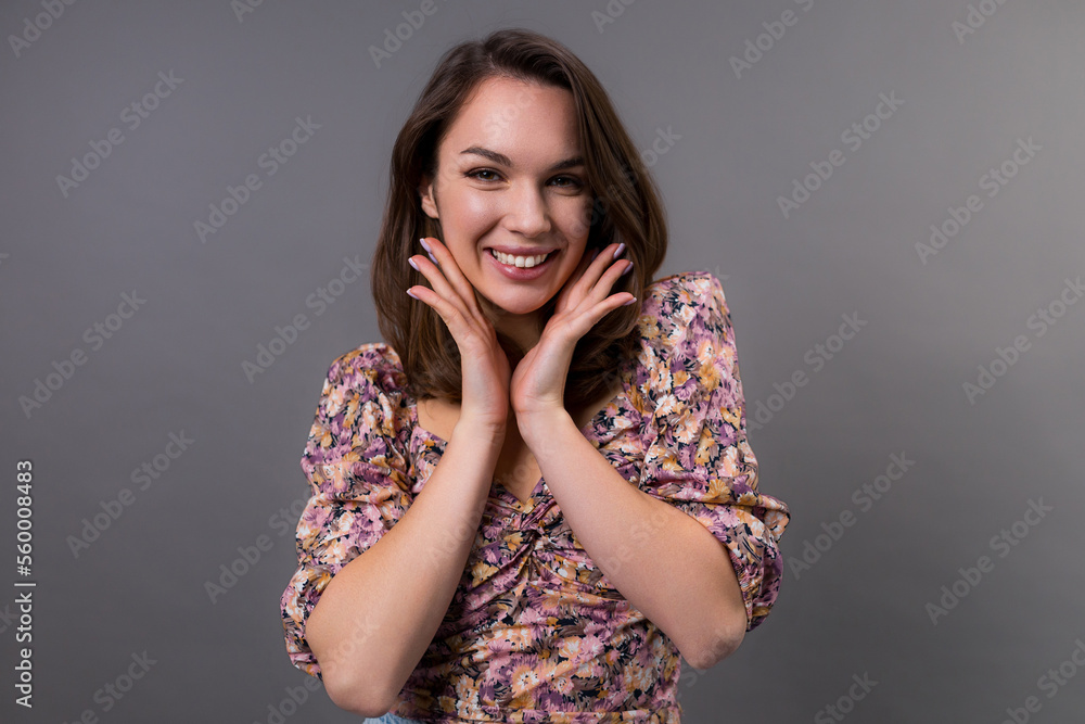 Portrait of a young woman with perfect skin on her face on a gray background. Skin care concept Portrait of a young woman with perfect skin on her face on a gray background. Skin care concept