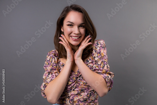 Portrait of a young woman with perfect skin on her face on a gray background. Skin care concept
