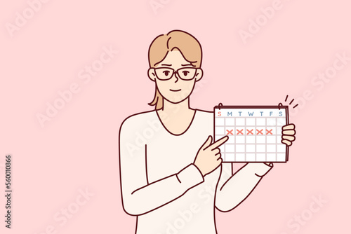 Young woman points finger at calendar with marks recommending time management or paying attention to date. Girl secretary in glasses announces important upcoming event. Flat vector illustration