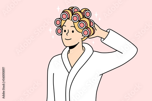 Smiling young woman in bathrobe and curlers on head getting ready. Happy female do beauty procedures at home. Vector illustration. 