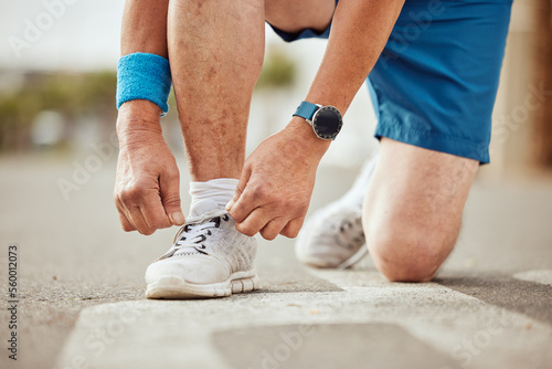 Runner, fitness or hands tie shoes to start training, cardio workout or sports exercise in city road. Legs, man or healthy sports athlete with running shoes or footwear laces ready for body goals