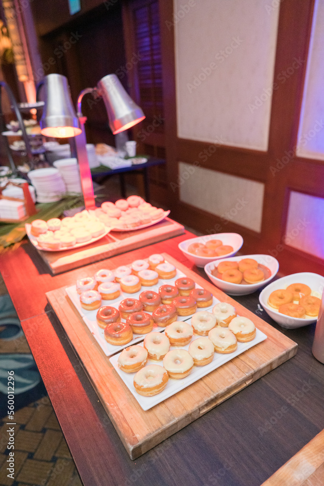 vanilla and fruit donuts on wooden table vanilla and fruit donuts on wooden table