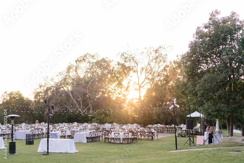 outdoor event, white chairs and tables placed outside