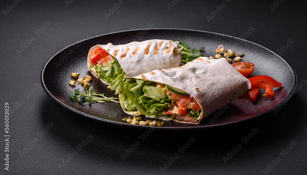 Delicious fresh shawarma with tomatoes, peppers, cucumber on a dark concrete background Delicious fresh shawarma with tomatoes, peppers, cucumber on a dark concrete background