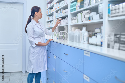 Female pharmacist making inventary in a drugstore