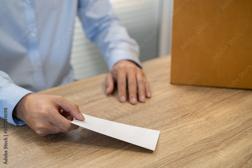 sending resignation letter to boss and Holding Stuff Resign Depress or carrying cardboard box by desk in office sending resignation letter to boss and Holding Stuff Resign Depress or carrying cardboard box by desk in office