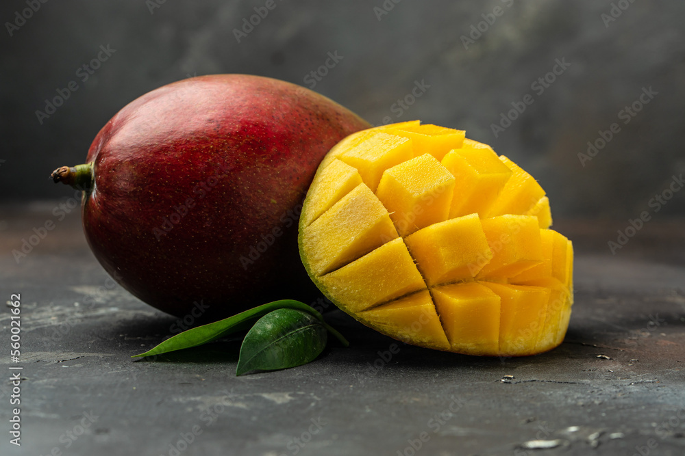 Mango tropical fruit on dark background. superfood concept Mango tropical fruit on dark background. superfood concept