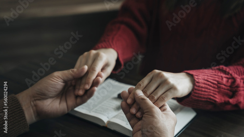 Asian men and women hands praying to god with the bible. Pray for god blessing. Religious beliefs Christian life crisis prayer to god.