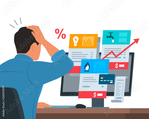 Worried man checking expensive utility bills on his computer
