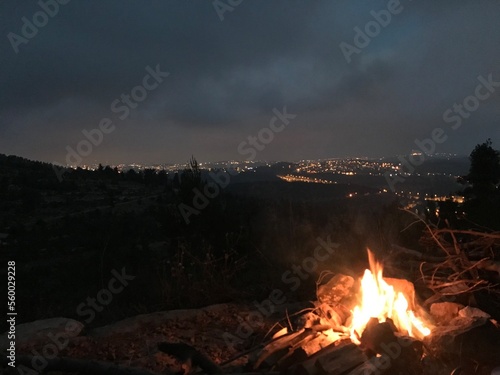 campfire in the forest in the Background light of Jerusalem 